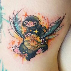 a small tattoo on the side of a woman's stomach with a monkey holding a kite