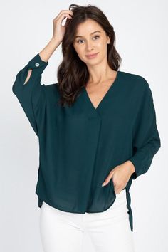 A great wardrobe go-to and staple you can effortlessly dress up or down in an instant. Team with your favorite leather look or denim and heels or booties for an evening and flats or cute sneakers for day time. V-neck, 3/4 sleeve, hi-lo flows top. Available in TEAL, RUST, OYSTER or BLACK. 100% POLYESTER. Modern V-neck Blouse For Fall, Spring V-neck Blouse With Rolled Sleeves, Chic Fall Tops With Shirttail Hem, Chic Fall Shirttail Hem Tops, Chic Shirttail Hem Top For Fall, Modern V-neck Fall Blouse, Trendy 3/4 Sleeve Blouse For Fall, Versatile 3/4 Sleeve Blouse For Fall, Modern Green Top For Fall