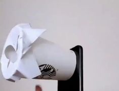 a starbucks coffee cup is being held up by a hand with a tissue paper on it