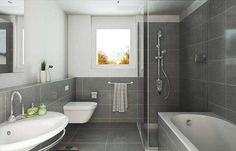 a bathroom with grey tiles and white fixtures, including a tub, sink, toilet and shower