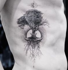 a man's back with a tree tattoo on his chest and an upside down image