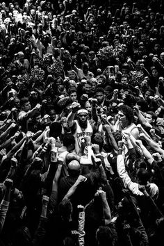 a large group of people standing around each other