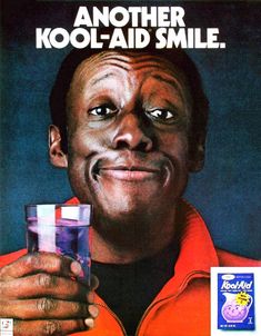 an advertisement for kool aid with a smiling man holding a glass in front of his face