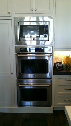 a stainless steel oven and microwave in a kitchen