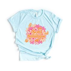 Looking for a cute versatile top to wear? Make sure to grab one of our Graphic tees! This soft and comfortable graphic tee is the perfect top for any outfit. It can be paired with biker shorts, jeans, or even a simple skirt/dress! This tee is true-to-size, so be sure to order your regular t-shirt size! If you are looking for a more oversized look, make sure to size up! Retro Slogan T-shirt For Spring, Fun Spring Tops With Screen Print, Spring Funny Print Graphic Tee, Funny Print Graphic Tee For Spring, Spring Graphic Tee With Slogan, Retro Pre-shrunk T-shirt For Spring, Spring Graphic Tee With Text Print, Cute Spring T-shirt With Text Print, Trendy Spring T-shirt In Soft Fabric