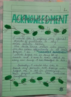 a piece of paper with writing on it that says acronomic development and green leaves