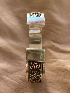 "This is a great silver and enamel cuff bracelet from Morocco. It measures just under 5/8\" (1,45 cm) at the widest and the inner diameter is just over 2 3/8\" (6,1 mm) wide. It is slightly adjustable as it is a cuff style bracelet. The bracelet features fantastic filigree-style wirework with unique-colored enamel." Silver Inlay Cuff Bracelet Bangle, Traditional Adjustable Enamel Bracelets, Bohemian Enamel Bangle Bracelets, Bohemian Enamel Bangle Bracelet, Traditional Silver Enamel Bangle, Handmade Bohemian Enamel Bracelets, Traditional Adjustable Cuff Bracelet With Inlay, Traditional Inlay Cuff Bangle Bracelet, Artisan Silver Cuff Bracelet With Inlay