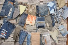 several pairs of jeans are hanging on a clothes line with other items attached to it