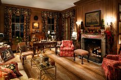 a living room filled with furniture and a fire place in the middle of a room