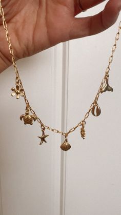 In stock! This is a pre made charm necklace! You will get the necklace as shown! Designed with high quality and durability in mind, the Pre-Made Beach Vibes Charm Necklace comes with multiple charms to complement any outfit or style. Its 16" chain ensures a comfortable fit for any neck size while still providing a stunning and fashionable look. Gold filled charm necklace & charms. 16” chain Cute Beachy Jewelry, Outfit Accessories Ideas Jewelry, Scandi Jewellery, Charm Necklace Ideas, Preppy Necklaces, Jewelry Product Shots, Surf Jewelry, Nail Bracelet, Beachy Jewelry