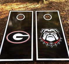 two black and white cornhole boards with bulldogs on them