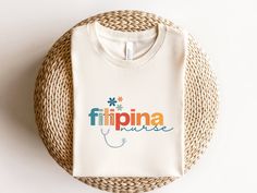 Filipina and proud~! ✨ Bella and Canvas brand shirt (light t-shirt fabric keeping you cool in the summer heat and ready for any occasion) ✨ 100% soft, Airlume combed and ringspun cotton ✨ Unisex adult sizing ✨ Perfect gift idea for your Filipino friends and family!   🧺 WASHING INSTRUCTIONS - Wash inside out, in cold water, on gentle cycle. Tumble dry low or let air dry. - Do not use fabric softeners or bleach. - Do not dry clean. Avoid ironing on the design. 📏📐 SIZE -Take a look at the photos to see a specific sizing chart for this t-shirt style - Please note that these shirts are unisex size meaning they are not women's fitted shirts. If you're going for a fitted shirt, we suggest to size down - Lay your favorite shirt at home flat and measure armpit to armpit to compare to the size ch White Letter Print T-shirt For Nursing, White Nursing T-shirt With Letter Print, White Cotton Nursing T-shirt, White Cotton Nursing Shirt, White Short Sleeve Nursing Shirt, White Nursing Friendly Short Sleeve Tops, Cotton Nursing Friendly T-shirt, Nurse Appreciation Gifts, Nurse Appreciation