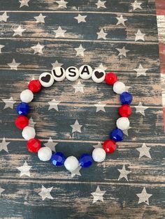 a red, white and blue beaded bracelet with the word usa on it