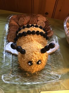 a cake made to look like an animal is on a table with other food items