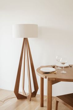 a wooden table with a white lamp on it