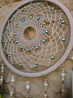 a close up of a dream catcher with beads