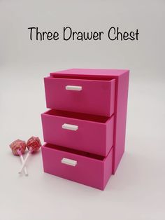 three drawer chest in pink with candy on the bottom and two lollipops next to it