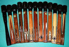 an assortment of wooden baseball bats lined up on a blue surface