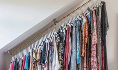 an organized closet with ties and scarves hanging on the wall next to a stair case