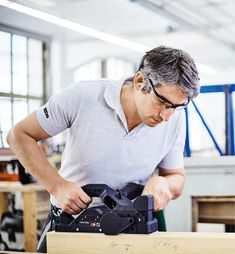 a man working with a camera in a shop