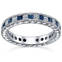 a white gold ring with blue sapphires and diamonds on the inside, set in 18k white gold