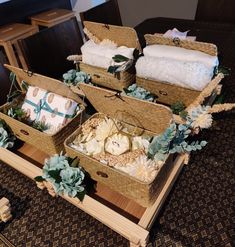 three baskets filled with baby goods sitting on top of a table