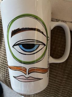 a coffee mug with an eye drawn on it