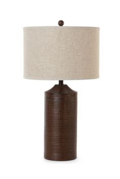 a brown table lamp with a beige shade on it and a white linen lampshade