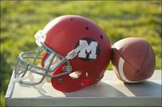 a football and helmet sitting on top of a table