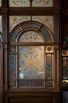 an ornate wooden door with stained glass panels