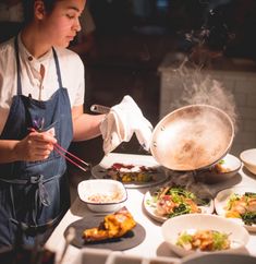 a woman cooking food on top of a stove