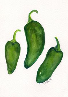 three green peppers sitting on top of a white surface