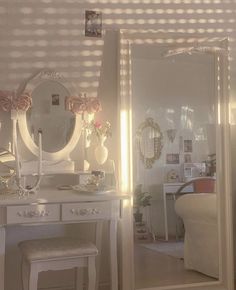 there is a vanity with a mirror and stool in the room