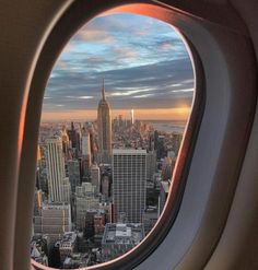 an airplane window looking out at the city