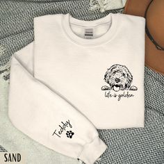 "Personalized Goldendoodle Sweatshirt | Custom Golden Doodle Gifts | Doodle Mom Sweatshirt | Personalized sleeve design NEW! Personalized doodle name sleeve design -  Great gift for Doodle Moms, Doodle Dads, Doodle Grandmas and Uncle's!  The sleeve design is printed on the side of the right sweatshirt sleeve.  HOW TO ORDER:  - Select the size and colour you would like - In the personalisation section state the following: 1) If you want the \"Life is Golden\" design to be placed in the centre of the sweatshirt, or the left 'pocket side'. 2) The doodles name eg. Teddy  Details: * Unisex Cotton Blend Lightweight Crewneck Sweatshirt * Loose Fit  * Pre-Shrunk  * Machine Washable  * Unisex Fit - Refer to sizing guide in photos for sizes  Care Instructions *PLEASE READ*  * Cold machine wash only Mom Doodle, Doodle Name, Goldendoodle Mom, Life Is Golden, Doodle Doodle, Mom Crewneck, Doodle Mom, Golden Design, Golden Doodle