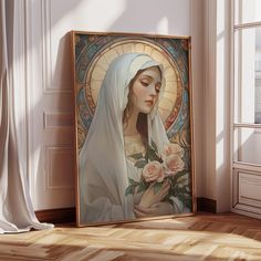 a painting of the virgin mary with roses in front of a white wall and wooden floor