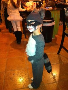 a little boy dressed up as a cat