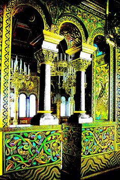 an ornately decorated room with columns and chandelier in the center is lit by colorful lights