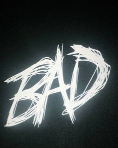 the word dad written in white chalk on a black background