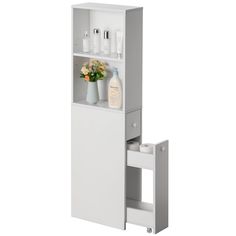 a white cabinet with flowers and bottles on it