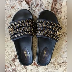 Excellent Condition Chanel Chain Slides. These Come In A Dark Navy Color With Beautiful Gold Chain Details And Cc Logos. These Are A European Size 39, However They Run About One Size Smaller And They Fit A True Us Size 8. Extremely Comfortable And Chic. Perfect For A Vacation Or Elevating Any Casual Outfit. I Have Worn Them To A Couple Of Events, Other Wise They Are Kept In Chanel Dust Bags With Tissues. Really No Signs Of Wear, Please See All The Photos. I Can Send More If Needed. Made In Italy Silk Lined Gold Details European 39 - Fits A True Us 8 Chanel Slides Will Come With Two Original Chanel Dust Bags. I No Longer Have The Box. Chanel Slides, Chanel Chain, Shoes Chanel, Slides Sandals, Chanel Shoes, Navy Color, Gold Details, Dark Navy, Blue Gold