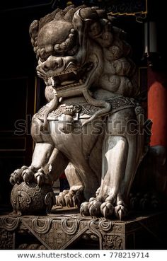 a stone lion statue sitting on top of a table