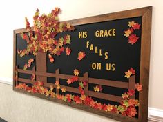 a bulletin board with leaves on it that says his grace fall's on us