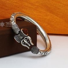 Amazing handcrafted plain shiny design work 925 sterling silver vintage design custom made oxidized silver personalized unisex gifting jewelry from India. Metal-925 sterling silver. Item type-trishul  Kada. Weight-36.710. grams. approx. Size-2-6 (2.375 inches inner diameter)We can easily adjust by twisting it. Width-1.0 centimeters stamped- 925. Finish-Oxidized. Makes excellent gifting for birthday, mother's day, father's day, Christmas day,valentinesday, wedding, anniversary gifts Traditional Sterling Silver Bangle With Polished Finish, Temple Jewelry Bangle With Oxidized Finish As Gift, Traditional Silver Bangle With Polished Finish, Silver Jewelry With Unique Design For Ceremonial Occasions, Handmade Sterling Silver Temple Jewelry Bangle, Handmade Silver Temple Jewelry Bracelets, Traditional Adjustable Bangle With Polished Finish, Symbolic Silver Bangle For Festivals, Silver Temple Jewelry Bracelet, Hallmarked