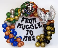 a wreath made out of balloons with the words from muggle to mrs