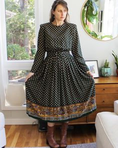 Striking, forest green, long sleeve dress, with wide belt, shoulder pads, pockets, and a paisley pattern throughout. Zips up the back, with elastic waist, and a flowy, full skirt. Material is a comfy rayon. In good overall vintage condition, with tons of life left, but several specific issues to note. The belt has some wear to the edges, with the loosest hole appearing self-punched. The skirt waist also has wear all along that seam, with a few holes. There's also a small hole at the back of the Green Long Sleeve Paisley Print Dresses, Green Long Sleeve Dress With Paisley Print, Green Paisley Print Long Sleeve Dresses, Bohemian Style Fall Dresses For Workwear, Bohemian Fall Dresses For Workwear, Vintage Belted Dress For Fall, Vintage Belted Dresses For Fall, Fall Vintage Belted Dress, Vintage Paisley Print Dresses For Fall