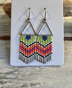 Fun summertime fringe beaded earrings! Three styles to choose from: Shimmery white AB, apricot and pale silk blue beads with silver lever back ear hooks, lime green color block triangles, and shades of purple with emerald green beads as accents beaded onto a small teardrop frame. Nickel and lead safe. Summer Fringe Chandelier Drop Earrings, Summer Fringe Dangle Chandelier Earrings, Summer Orange Beaded Earrings With Tiny Beads, Spring Bohemian Beaded Dangling Earrings, Summer Multicolor Beaded Fringe Chandelier Earrings, Bohemian Jewelry With Dangling Beads For Spring, Summer Orange Earrings With Tiny Beads, Bohemian Spring Jewelry With Dangling Beads, Summer Beaded Fringe Tassel Dangle Earrings