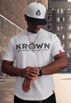 White Designer T-Shirt GUARANTEED SAME DAY SHIPPING! Get your official "Onassis Krown" flagship t-shirt. This t-shirt comes in the two color options of black or white with a slight curved hem bottom on the front and back of the shirt. Both styles feature the Krown brand logo on the front center chest with the tag line "If you like the finer things in life... it's OK!" underneath as well as the Onassis Krown signature over the top left chest. On the left sleeve and left bottom of the curved hem a Nipsey Hussle Crenshaw, Ok Logo, Streetwear Shirts, Urban Clothing, Hip Hop Outfits, Red Label, Street Wear Urban, Urban Outfits, Hip Hop Fashion