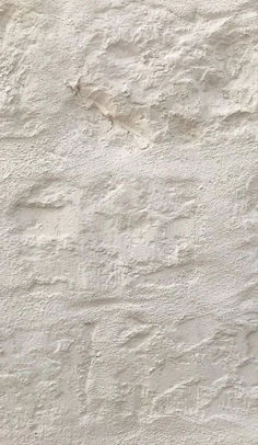 a white stucco wall textured with cement