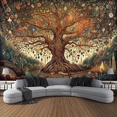 a living room with a large tree mural on the wall and couch in front of it